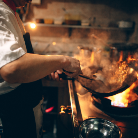 A chef cooking over an open flame